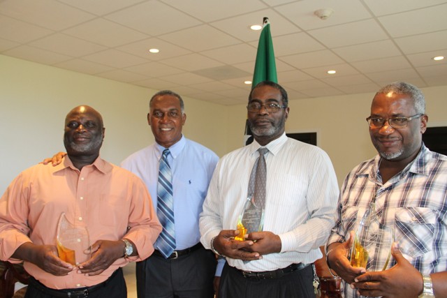 The Dore Brothers (left) Allister, Lanny (second from right) and Wrenford (right) showing off their individual tokens of appreciation rom the Nevis Island Administration for their contribution to music on Nevis with Premier of Nevis Hon. Vance Amory (second from left) at the St. Christopher and Nevis Social Security Board’s conference room at Pinney’s on October 25, 2016